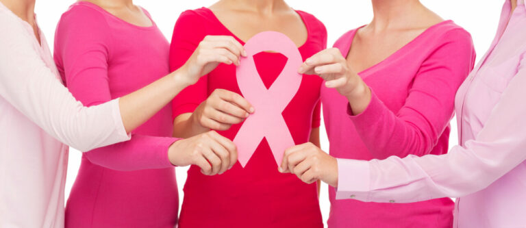 Close up of women with cancer awareness ribbons